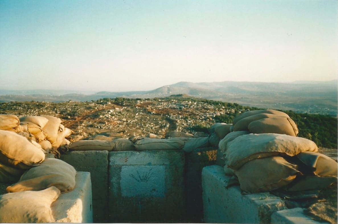 A military trench in a desert landscape.