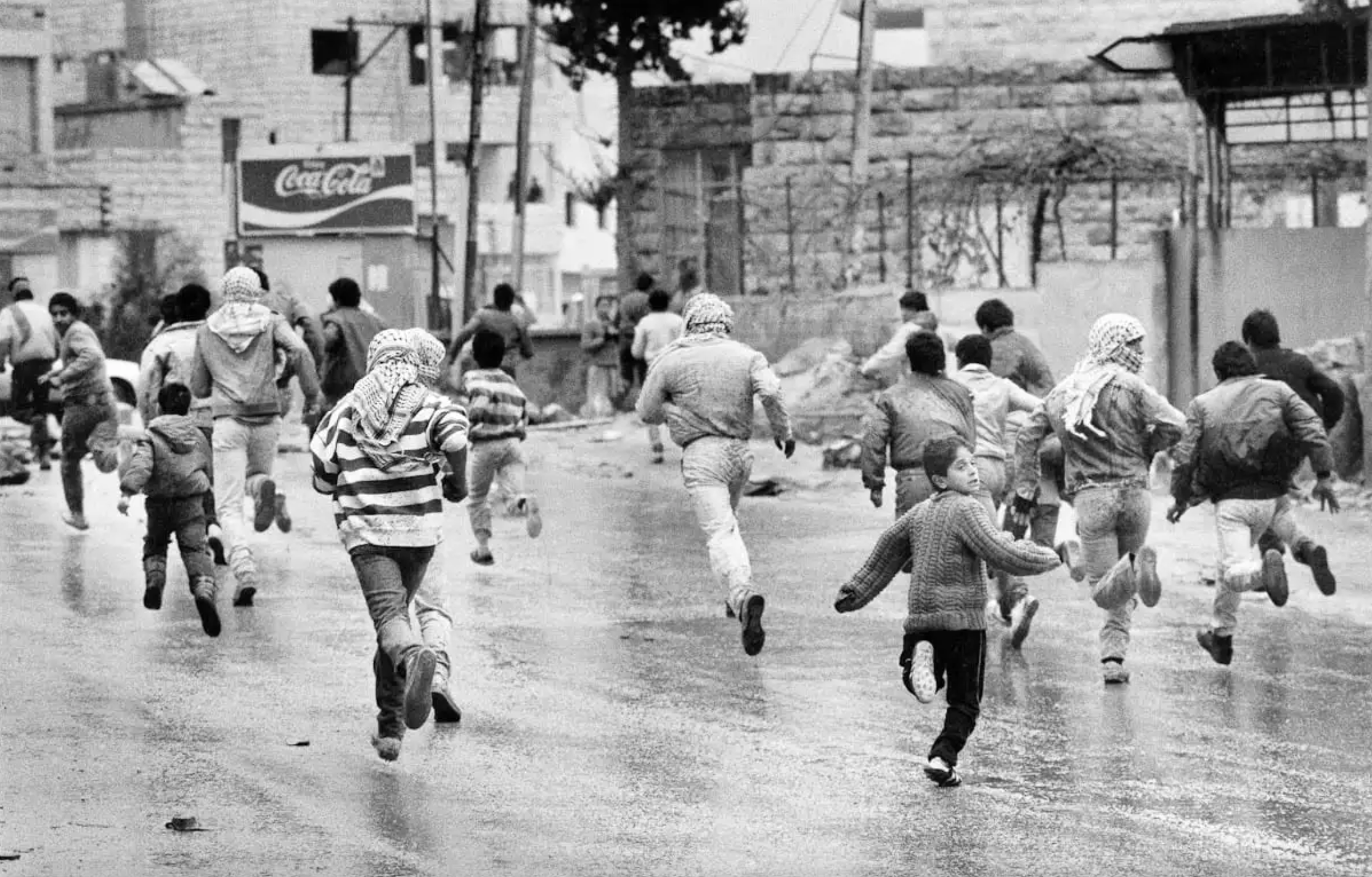 An image of Palestinian children and youths seeking shelter from an Israeli attack during the First Intifada, ca. 1988