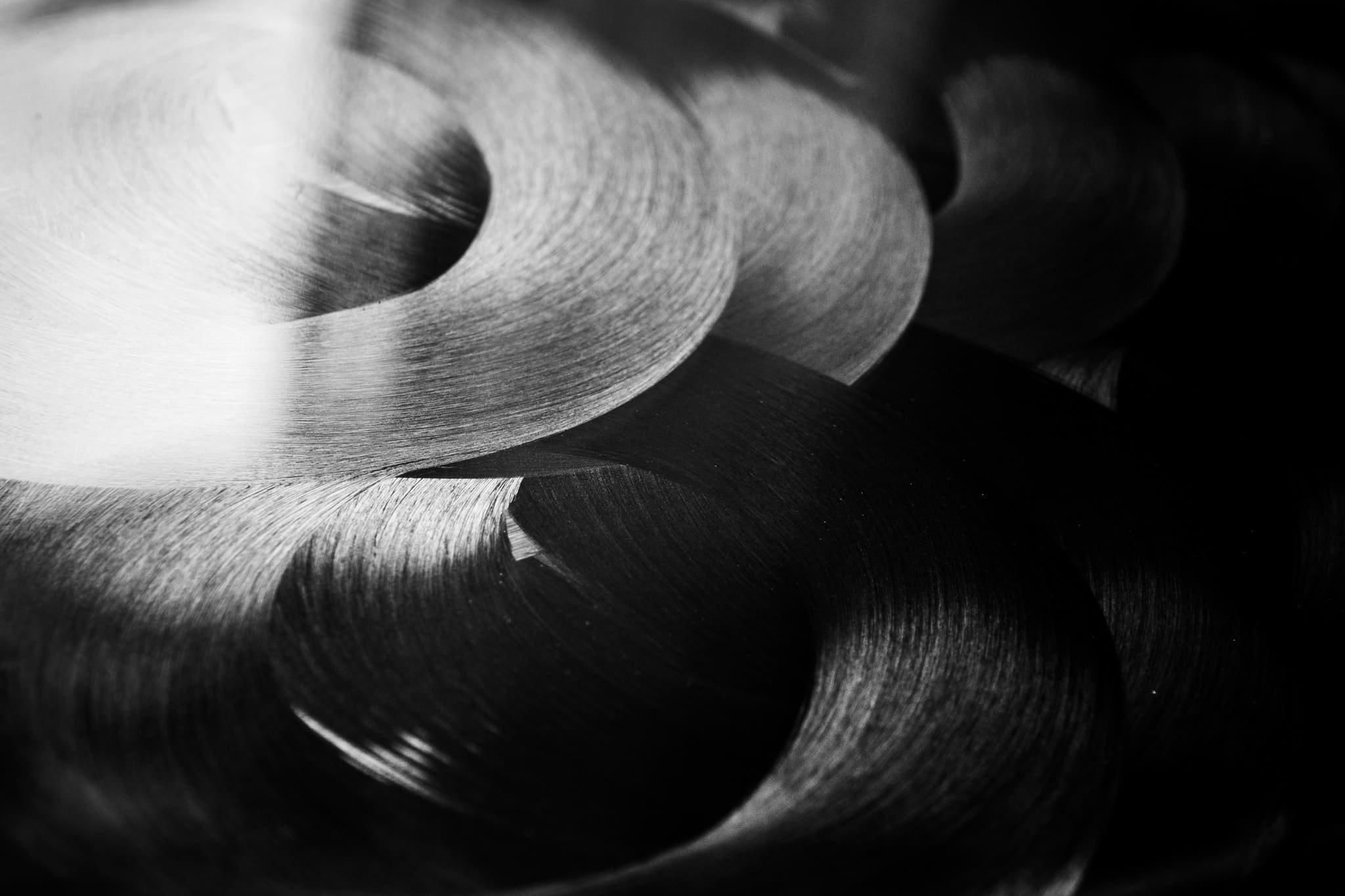 An abstract image of entangled white circles against a black background.