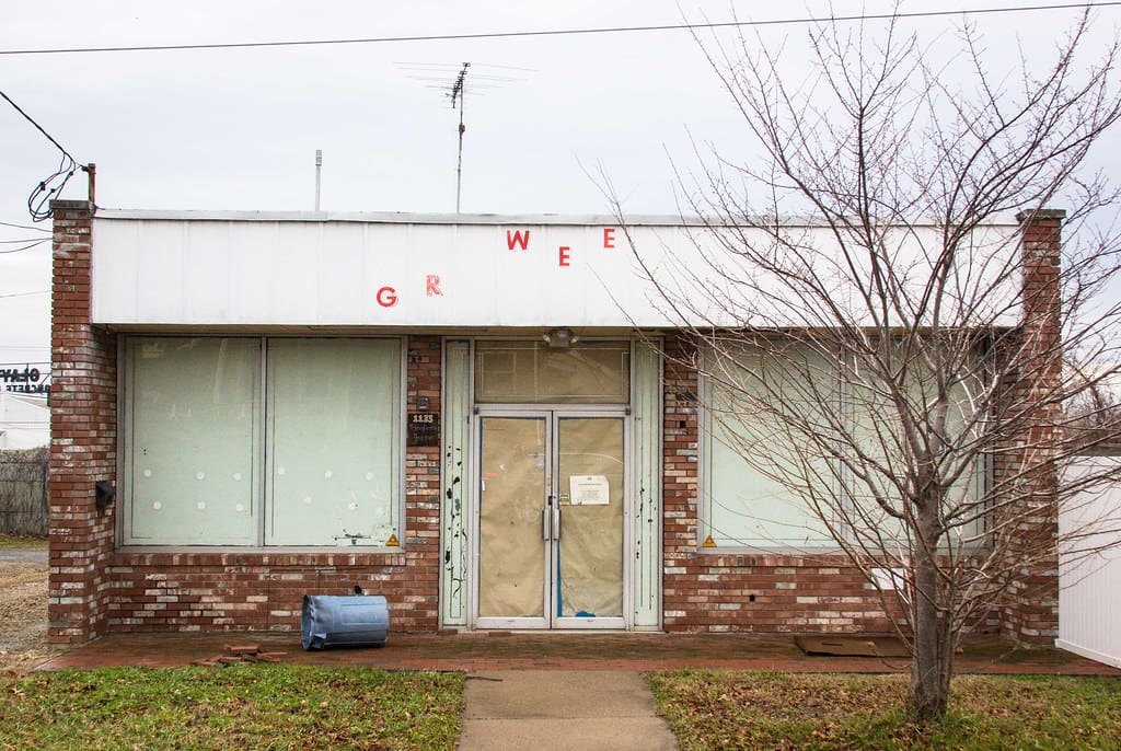 An image of an abandoned storefront in Trenton, NJ. On the unfinished marquee, the letters G, R, W, and E are visible. "Trenton, NJ" by like, totally is licensed under CC BY-NC-ND 2.0.
