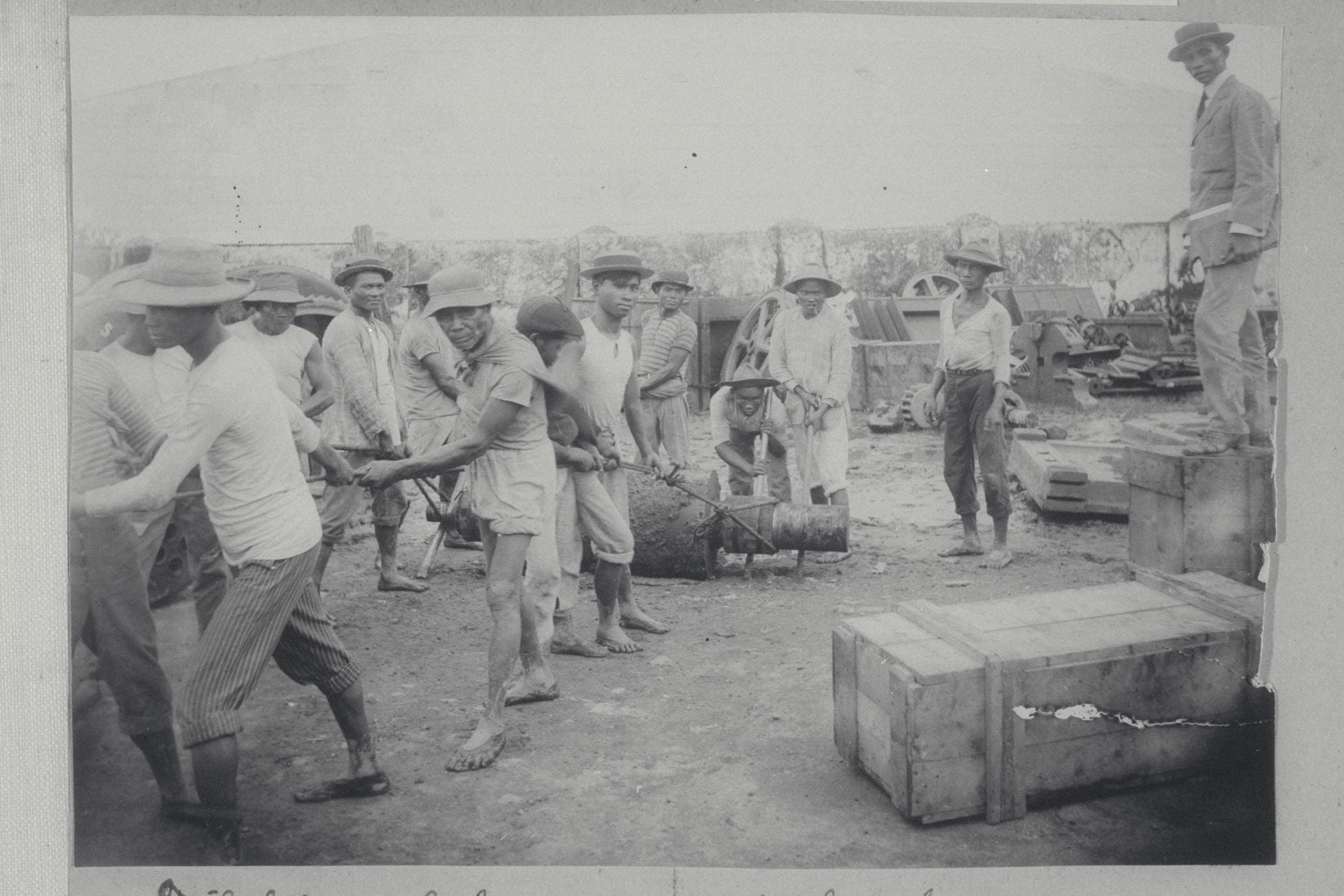An image of Filipino workers monitored by their boss. Image title: "Filipino laborers working as the boss looks on." Credit: University of Wisconsin-Madison Digital Collections: https://search.library.wisc.edu/digital/AYNTYG6VPJODVF86