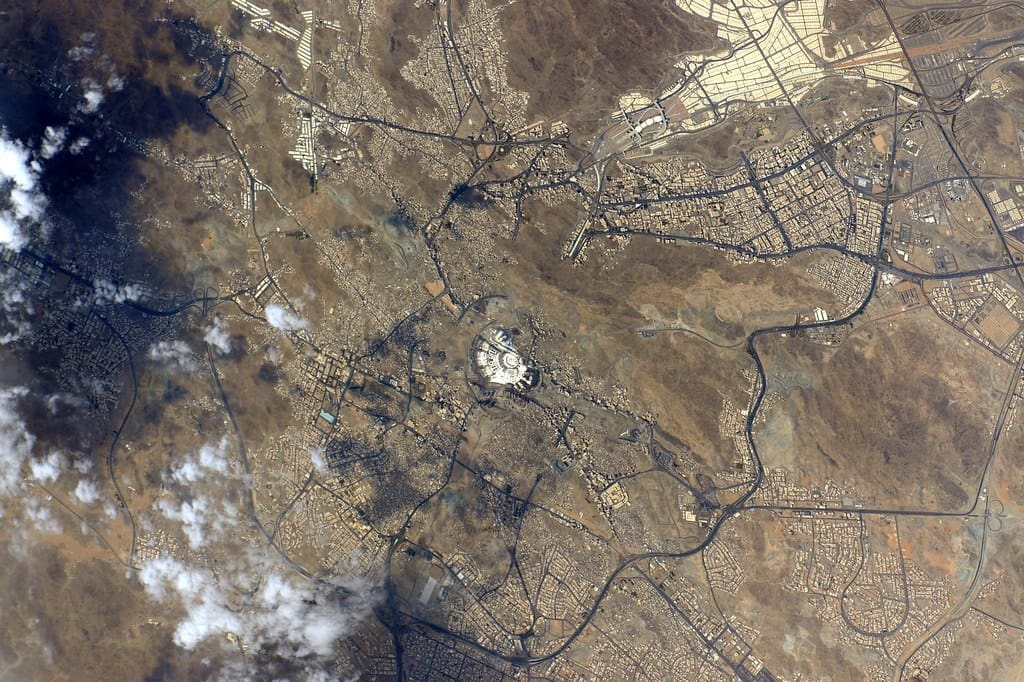 An aerial view of Saudi Arabia, including the city of Makkah, Masjid Al-Haram and the Kaaba. "Mecca" by NASA Johnson is licensed under CC BY-NC 2.0.